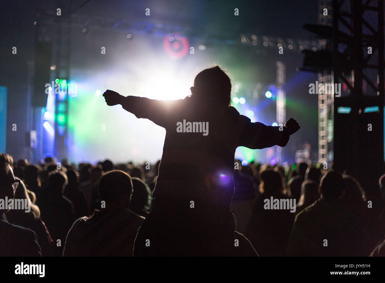 CROWD SCENE DANCING ON SHOULDERS IN SILHOUETTE: People dance wildly on one another's shoulders in silhouette in stage lighting as the crowd in the Far Out Tent during the LIARS set on Day Two of the Green Man music festival in Glanusk Park, Brecon, Wales on 19th August 2017. Credit: Rob Watkins/Alamy Live News Stock Photo