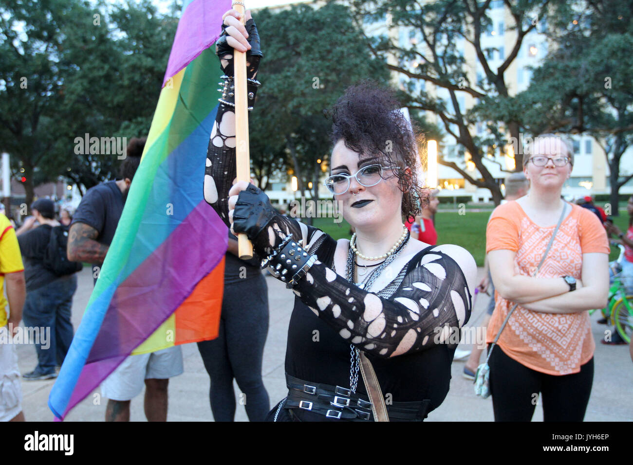 Dallas, Texas, USA. 19th Aug, 2017. A protestor holds an equality multicolor flag in support of gays, LGBT and all minorities during the Anti Racism Rall in front of City Hall in downtown Dallas on Sturday August 19, 2017 Credit: Jaime Carrero/ZUMA Wire/ZUMAPRESS.com/Alamy Live News Stock Photo
