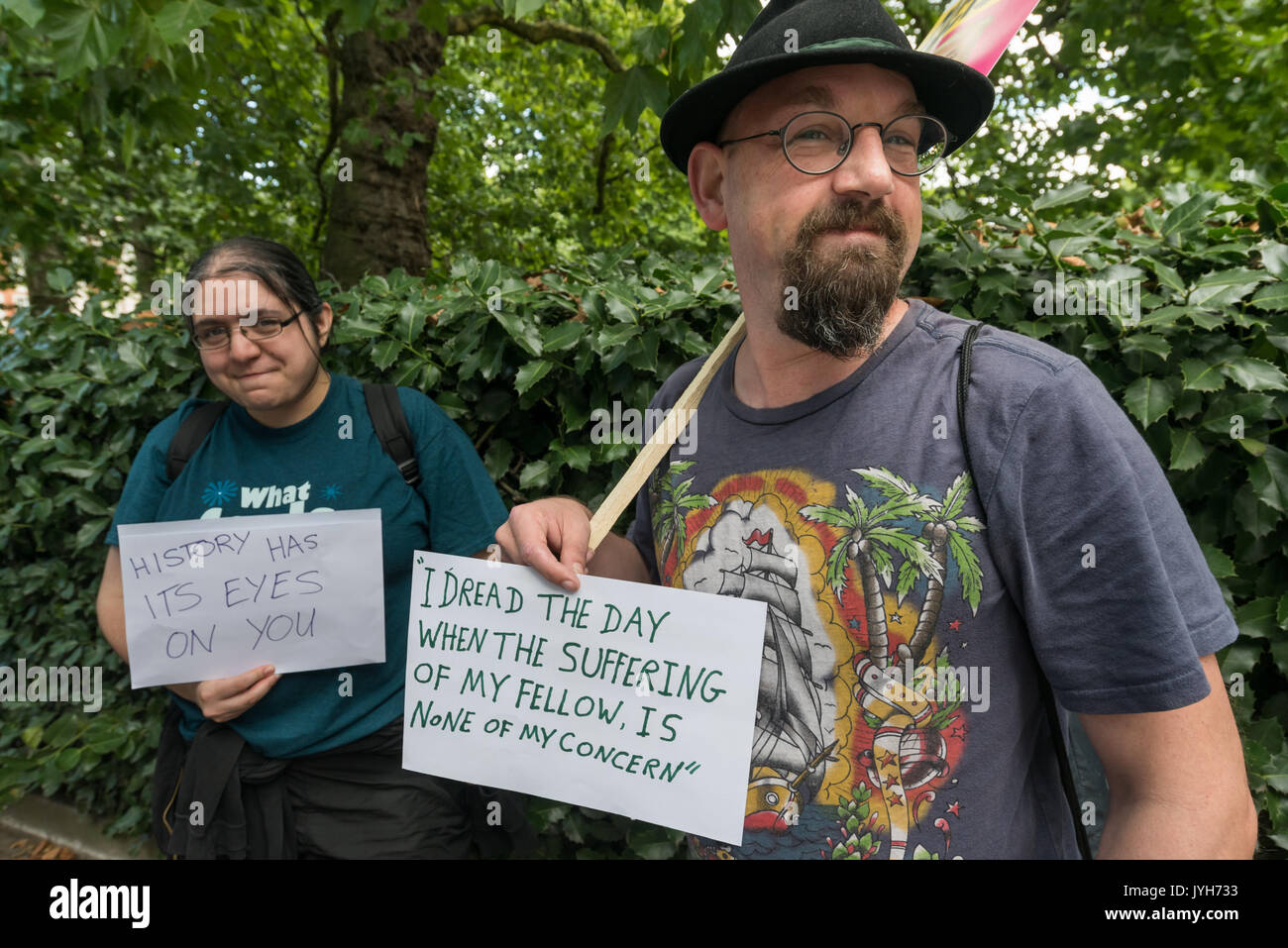 London, UK. 19th Aug, 2017. Campaigners with hand-written posters at the protest by Stand Up to Trump, an organisation supported by around 20 organisations including the CWU, NUT, Unite, UCU, CND, Stop the War, Campaign Against Climate Change, Muslim Association of Britain and others outside the US Embassy. Korea and the invasio Stock Photo