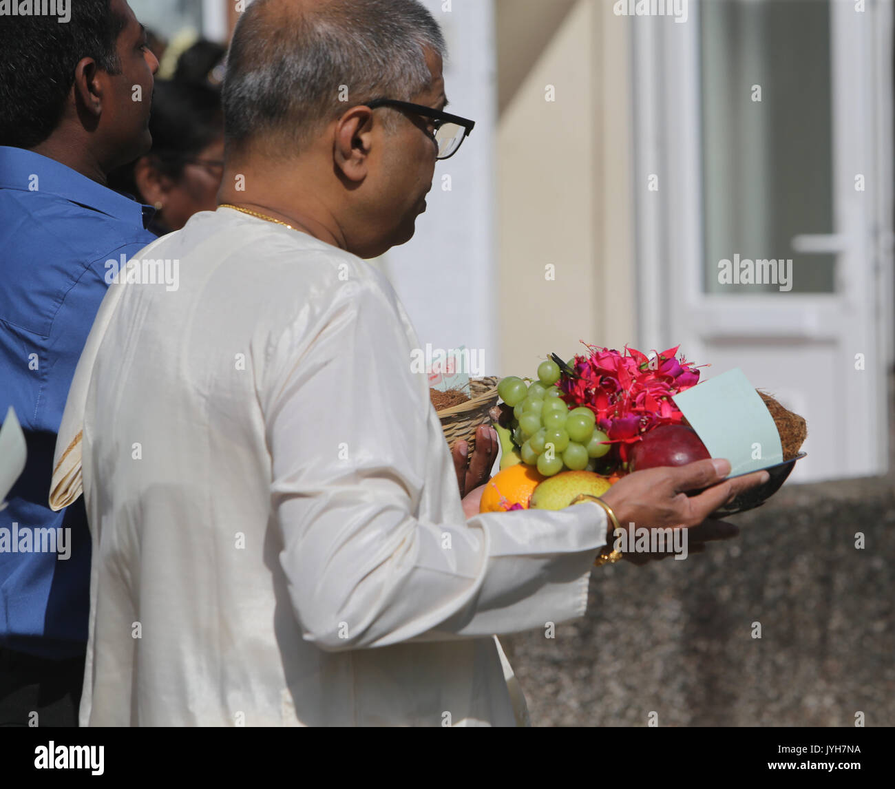 London, UK. 20th Aug, 2017. The London Sri Murgan Temple in East London celebrated the Chariot festival, stating with the blessing of the deities inside the temple, after taken into to a chariot where huge crowds gathering to follow it trough the streets of East Ham, in a colorful rainbow of colours, food was blessed by the priest and passed back for the people to take home and eat Credit: Paul Quezada-Neiman/Alamy Live News Stock Photo