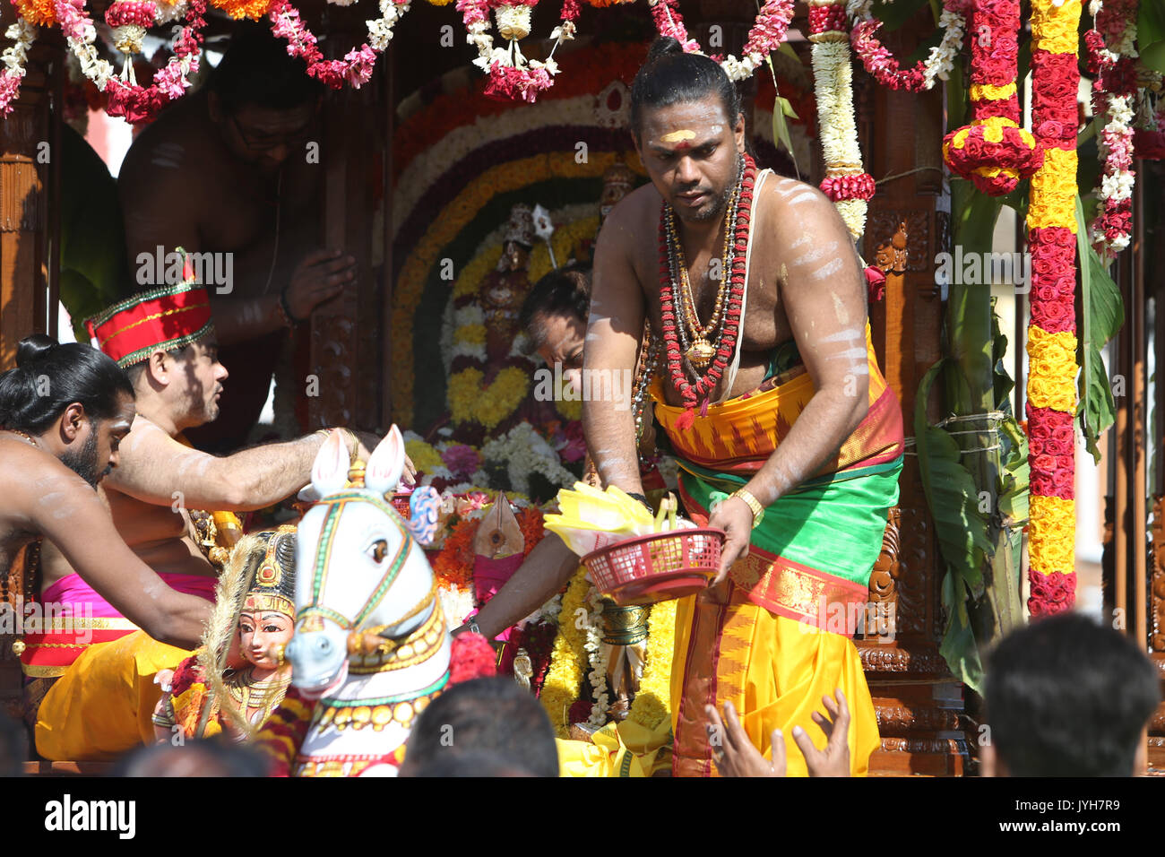 London, UK. 20th Aug, 2017. The London Sri Murgan Temple in East London celebrated the Chariot festival, stating with the blessing of the deities inside the temple, after taken into to a chariot where huge crowds gathering to follow it trough the streets of East Ham, in a colorful rainbow of colours, food was blessed by the priest and passed back for the people to take home and eat Credit: Paul Quezada-Neiman/Alamy Live News Stock Photo
