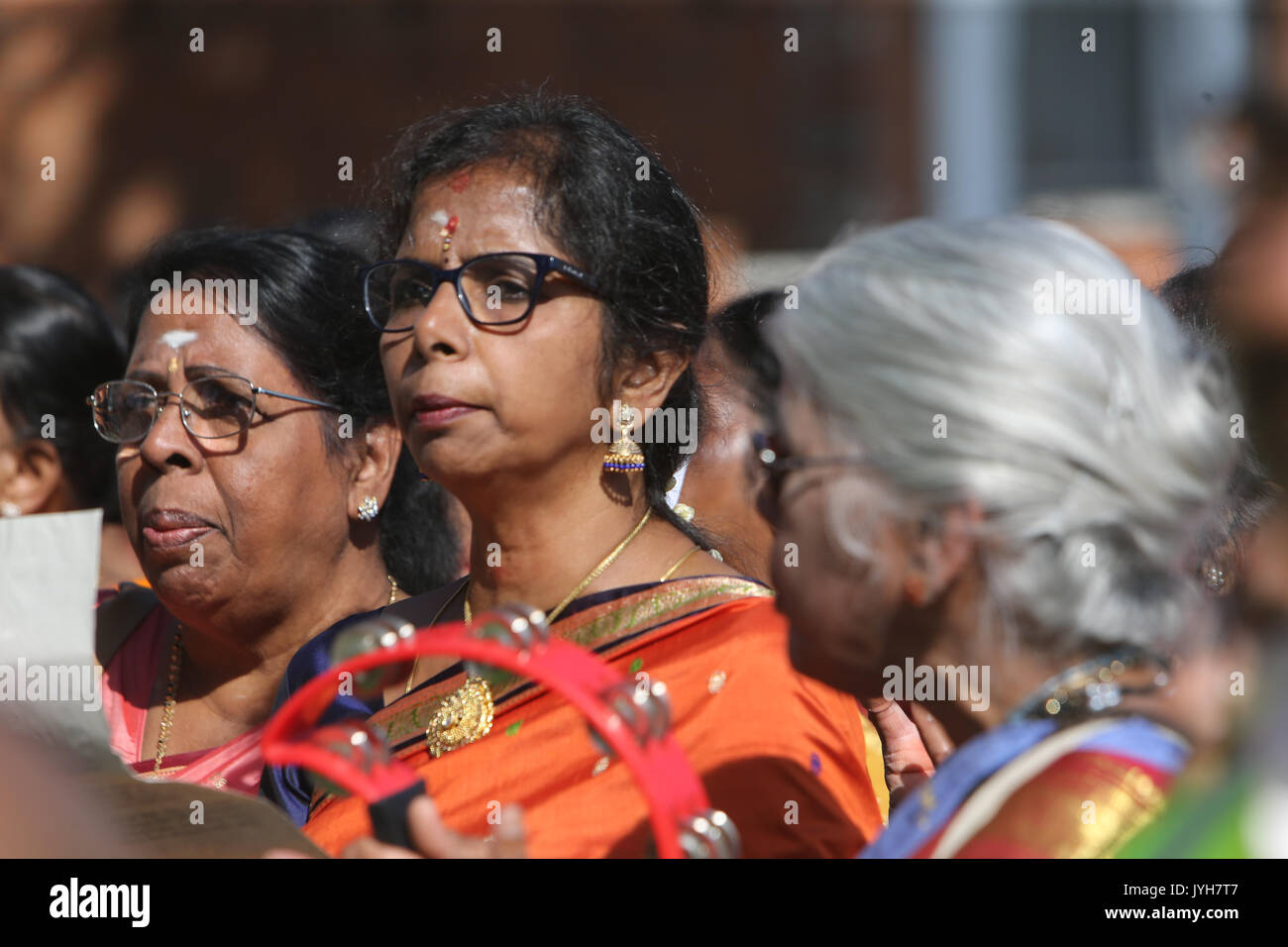 London, UK. 20th Aug, 2017. The London Sri Murgan Temple in East London celebrated the Chariot festival, stating with the blessing of the deities inside the temple, after taken into to a chariot where huge crowds gathering to follow it trough the streets of East Ham, in a colorful rainbow of colours, food was blessed by the priest and passed back for the people to take home and eat Credit: Paul Quezada-Neiman/Alamy Live News Stock Photo