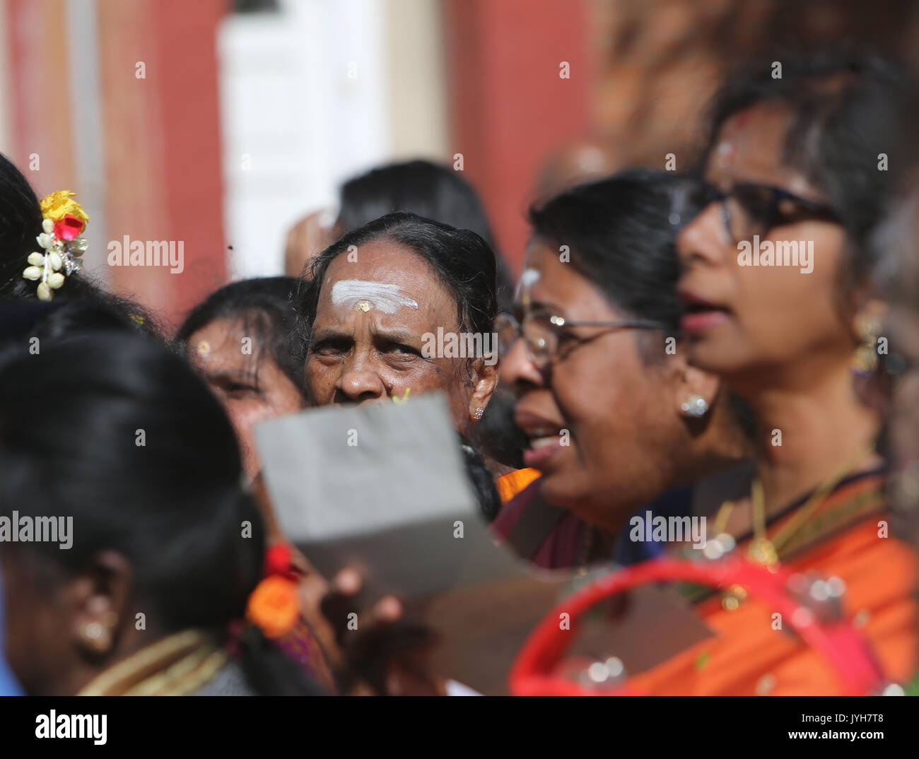 London, UK. 20th Aug, 2017. The London Sri Murgan Temple in East London celebrated the Chariot festival, stating with the blessing of the deities inside the temple, after taken into to a chariot where huge crowds gathering to follow it trough the streets of East Ham, in a colorful rainbow of colours, food was blessed by the priest and passed back for the people to take home and eat Credit: Paul Quezada-Neiman/Alamy Live News Stock Photo