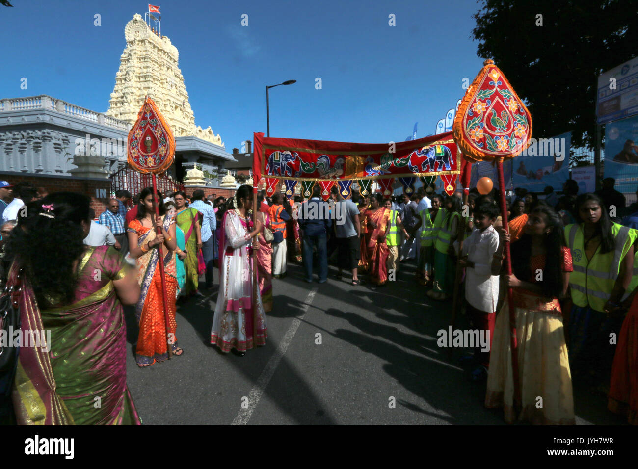 London, UK. 20th Aug, 2017. The London Sri Murgan Temple in East London celebrated the Chariot festival, stating with the blessing of the deities inside the temple, after taken into to a chariot where huge crowds gathering to follow it trough the streets of East Ham, in a colorful rainbow of colours, food was blessed by the priest and passed back for the people to take home and eat Credit: Paul Quezada-Neiman/Alamy Live News Stock Photo