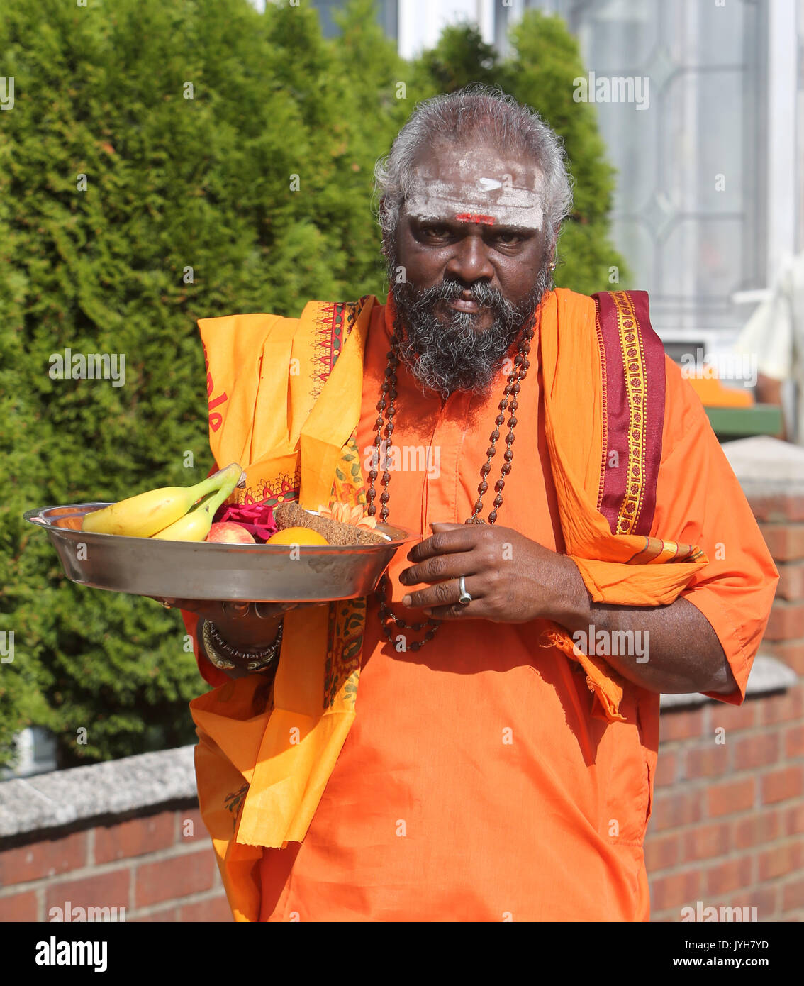 London, UK. 20th Aug, 2017. The London Sri Murgan Temple in East London celebrated the Chariot festival, stating with the blessing of the deities inside the temple, after taken into to a chariot where huge crowds gathering to follow it trough the streets of East Ham, in a colorful rainbow of colours, food was blessed by the priest and passed back for the people to take home and eat Credit: Paul Quezada-Neiman/Alamy Live News Stock Photo