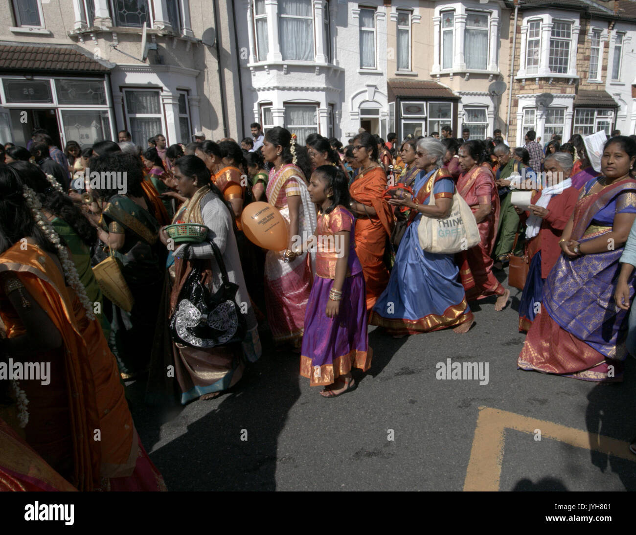 London, UK. 20th Aug, 2017. The London Sri Murgan Temple in East London celebrated the Chariot festival, stating with the blessing of the deities inside the temple, after taken into to a chariot where huge crowds gathering to follow it trough the streets of East Ham, in a colorful rainbow of colours, food was blessed by the priest and passed back for the people to take home and eat Credit: Paul Quezada-Neiman/Alamy Live News Stock Photo