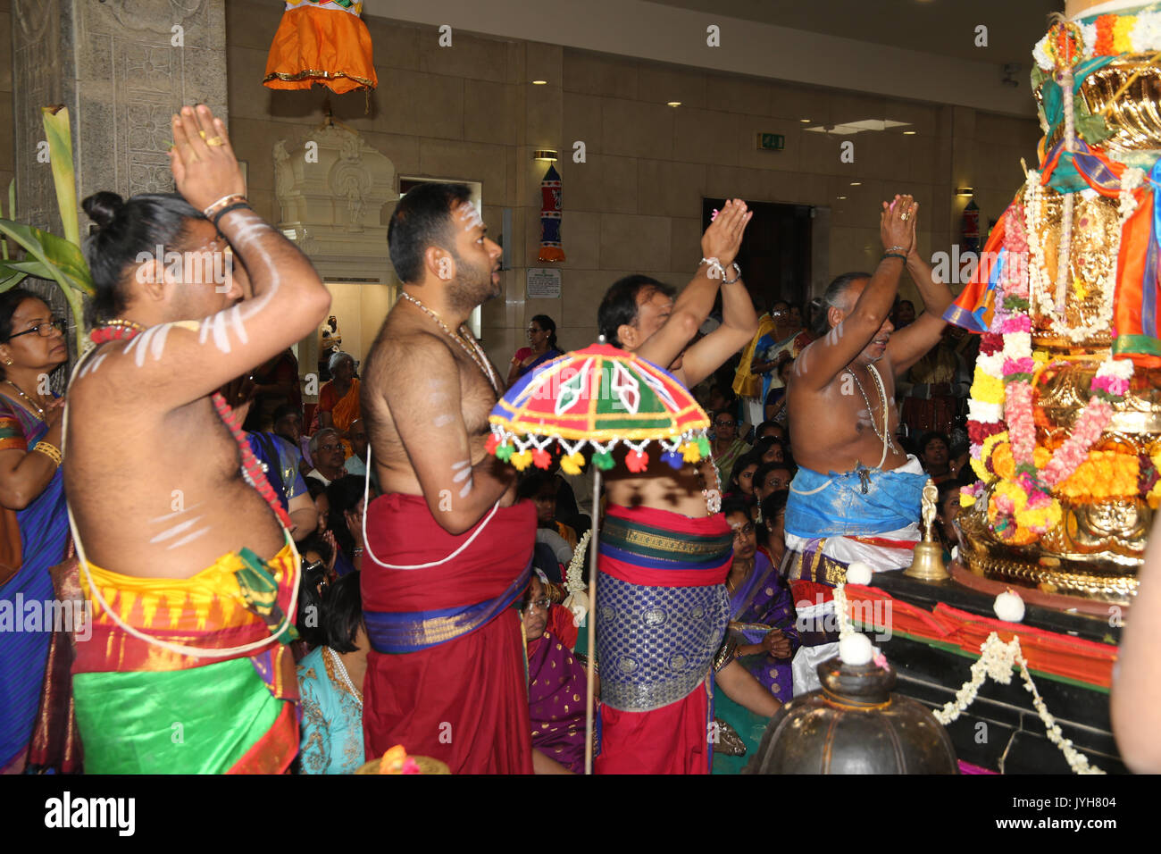 London, UK. 20th Aug, 2017. The London Sri Murgan Temple in East London celebrated the Chariot festival, stating with the blessing of the deities inside the temple, after taken into to a chariot where huge crowds gathering to follow it trough the streets of East Ham, in a colorful rainbow of colours, food was blessed by the priest and passed back for the people to take home and eat Credit: Paul Quezada-Neiman/Alamy Live News Stock Photo