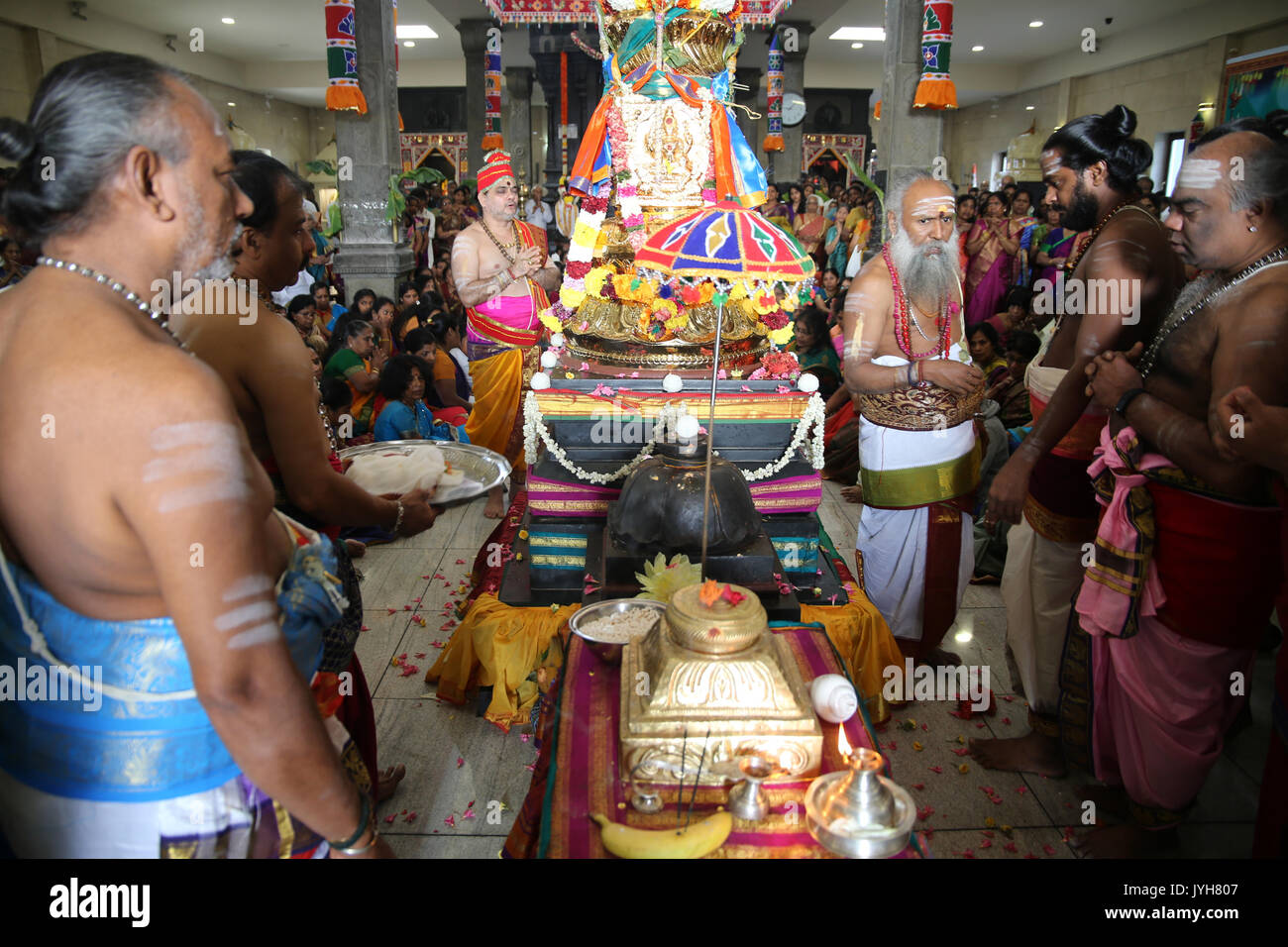 London, UK. 20th Aug, 2017. The London Sri Murgan Temple in East London celebrated the Chariot festival, stating with the blessing of the deities inside the temple, after taken into to a chariot where huge crowds gathering to follow it trough the streets of East Ham, in a colorful rainbow of colours, food was blessed by the priest and passed back for the people to take home and eat Credit: Paul Quezada-Neiman/Alamy Live News Stock Photo