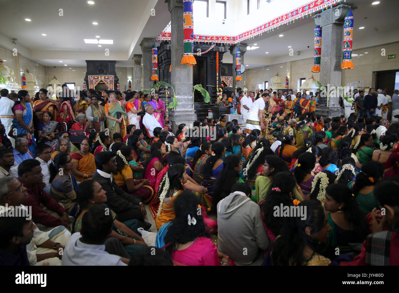 London, UK. 20th Aug, 2017. The London Sri Murgan Temple in East London celebrated the Chariot festival, stating with the blessing of the deities inside the temple, after taken into to a chariot where huge crowds gathering to follow it trough the streets of East Ham, in a colorful rainbow of colours, food was blessed by the priest and passed back for the people to take home and eat Credit: Paul Quezada-Neiman/Alamy Live News Stock Photo