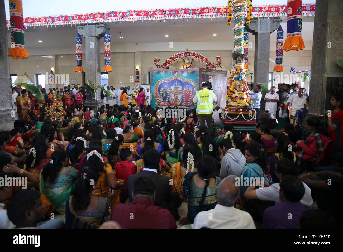 London, UK. 20th Aug, 2017. The London Sri Murgan Temple in East London celebrated the Chariot festival, stating with the blessing of the deities inside the temple, after taken into to a chariot where huge crowds gathering to follow it trough the streets of East Ham, in a colorful rainbow of colours, food was blessed by the priest and passed back for the people to take home and eat Credit: Paul Quezada-Neiman/Alamy Live News Stock Photo