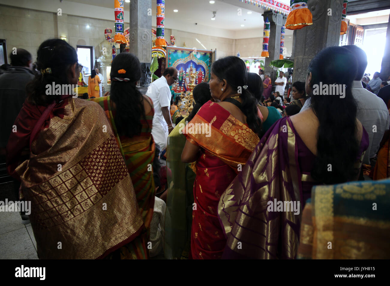 London, UK. 20th Aug, 2017. The London Sri Murgan Temple in East London celebrated the Chariot festival, stating with the blessing of the deities inside the temple, after taken into to a chariot where huge crowds gathering to follow it trough the streets of East Ham, in a colorful rainbow of colours, food was blessed by the priest and passed back for the people to take home and eat Credit: Paul Quezada-Neiman/Alamy Live News Stock Photo