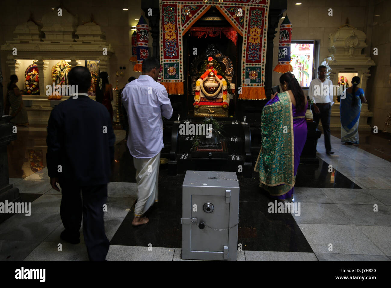 London, UK. 20th Aug, 2017. The London Sri Murgan Temple in East London celebrated the Chariot festival, stating with the blessing of the deities inside the temple, after taken into to a chariot where huge crowds gathering to follow it trough the streets of East Ham, in a colorful rainbow of colours, food was blessed by the priest and passed back for the people to take home and eat Credit: Paul Quezada-Neiman/Alamy Live News Stock Photo