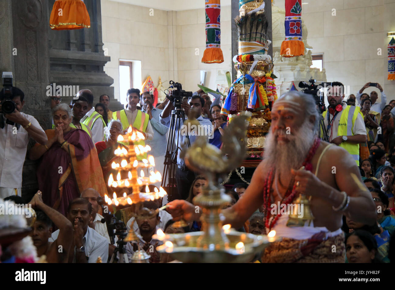 London, UK. 20th Aug, 2017. The London Sri Murgan Temple in East London celebrated the Chariot festival, stating with the blessing of the deities inside the temple, after taken into to a chariot where huge crowds gathering to follow it trough the streets of East Ham, in a colorful rainbow of colours, food was blessed by the priest and passed back for the people to take home and eat Credit: Paul Quezada-Neiman/Alamy Live News Stock Photo