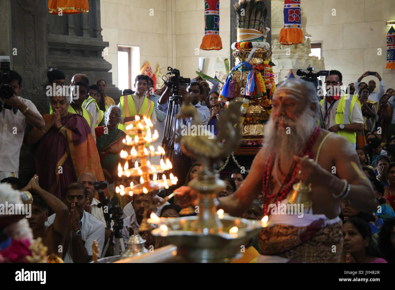 London, UK. 20th Aug, 2017. The London Sri Murgan Temple in East London celebrated the Chariot festival, stating with the blessing of the deities inside the temple, after taken into to a chariot where huge crowds gathering to follow it trough the streets of East Ham, in a colorful rainbow of colours, food was blessed by the priest and passed back for the people to take home and eat Credit: Paul Quezada-Neiman/Alamy Live News Stock Photo