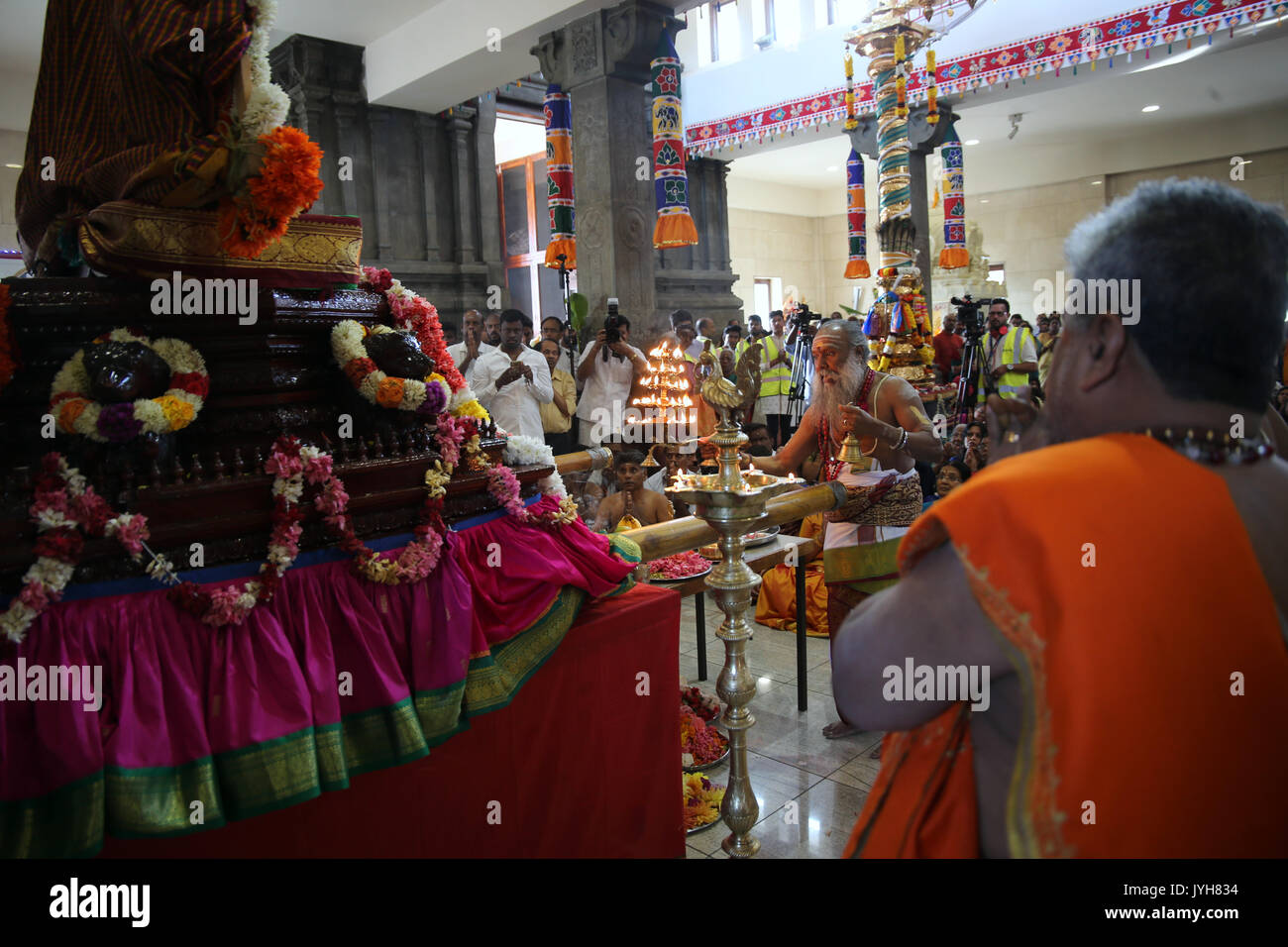 London, UK. 20th Aug, 2017. The London Sri Murgan Temple in East London celebrated the Chariot festival, stating with the blessing of the deities inside the temple, after taken into to a chariot where huge crowds gathering to follow it trough the streets of East Ham, in a colorful rainbow of colours, food was blessed by the priest and passed back for the people to take home and eat Credit: Paul Quezada-Neiman/Alamy Live News Stock Photo