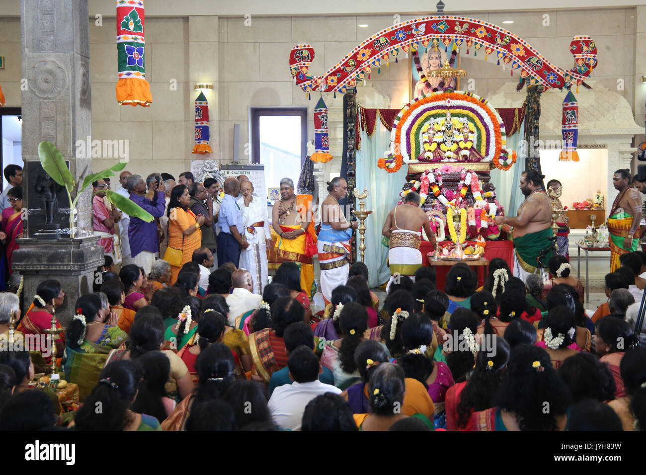 London, UK. 20th Aug, 2017. The London Sri Murgan Temple in East London celebrated the Chariot festival, stating with the blessing of the deities inside the temple, after taken into to a chariot where huge crowds gathering to follow it trough the streets of East Ham, in a colorful rainbow of colours, food was blessed by the priest and passed back for the people to take home and eat Credit: Paul Quezada-Neiman/Alamy Live News Stock Photo
