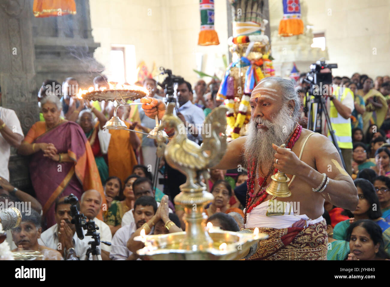 London, UK. 20th Aug, 2017. The London Sri Murgan Temple in East London celebrated the Chariot festival, stating with the blessing of the deities inside the temple, after taken into to a chariot where huge crowds gathering to follow it trough the streets of East Ham, in a colorful rainbow of colours, food was blessed by the priest and passed back for the people to take home and eat Credit: Paul Quezada-Neiman/Alamy Live News Stock Photo