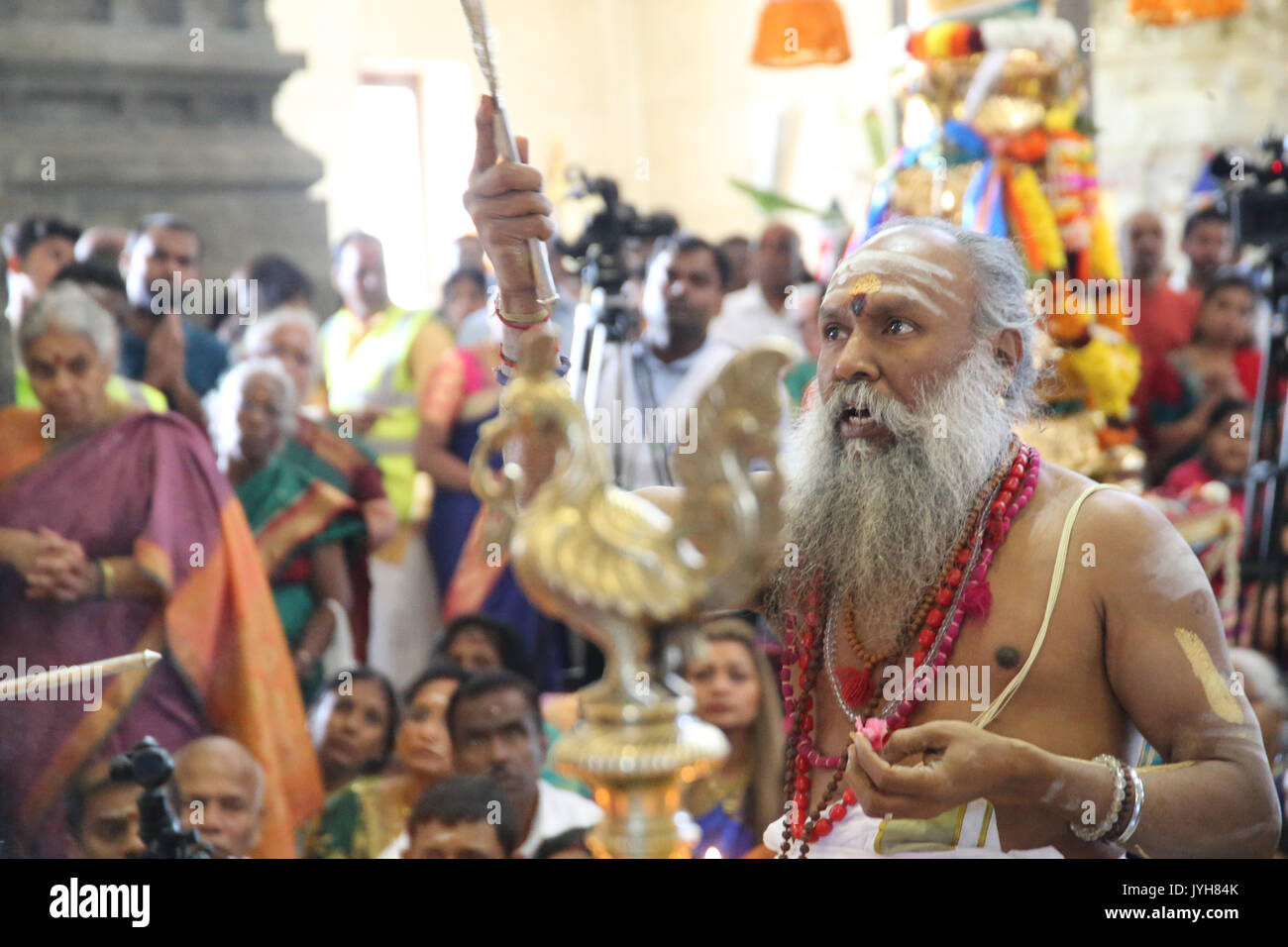 London, UK. 20th Aug, 2017. The London Sri Murgan Temple in East London celebrated the Chariot festival, stating with the blessing of the deities inside the temple, after taken into to a chariot where huge crowds gathering to follow it trough the streets of East Ham, in a colorful rainbow of colours, food was blessed by the priest and passed back for the people to take home and eat Credit: Paul Quezada-Neiman/Alamy Live News Stock Photo