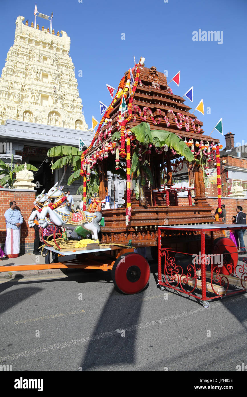 London, UK. 20th Aug, 2017. The London Sri Murgan Temple in East London celebrated the Chariot festival, stating with the blessing of the deities inside the temple, after taken into to a chariot where huge crowds gathering to follow it trough the streets of East Ham, in a colorful rainbow of colours, food was blessed by the priest and passed back for the people to take home and eat Credit: Paul Quezada-Neiman/Alamy Live News Stock Photo
