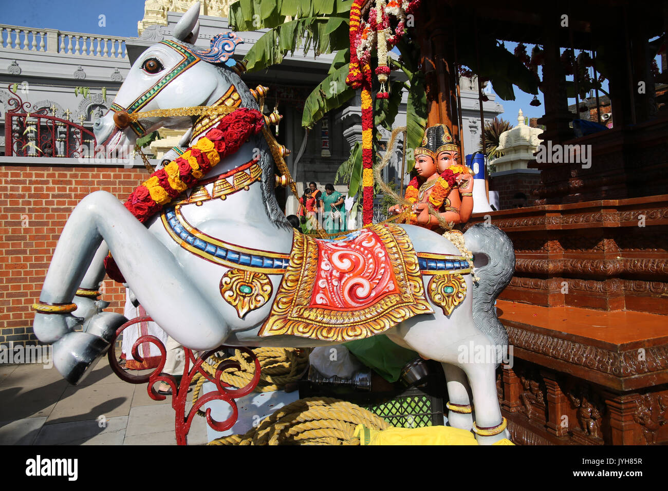 London, UK. 20th Aug, 2017. The London Sri Murgan Temple in East London celebrated the Chariot festival, stating with the blessing of the deities inside the temple, after taken into to a chariot where huge crowds gathering to follow it trough the streets of East Ham, in a colorful rainbow of colours, food was blessed by the priest and passed back for the people to take home and eat Credit: Paul Quezada-Neiman/Alamy Live News Stock Photo