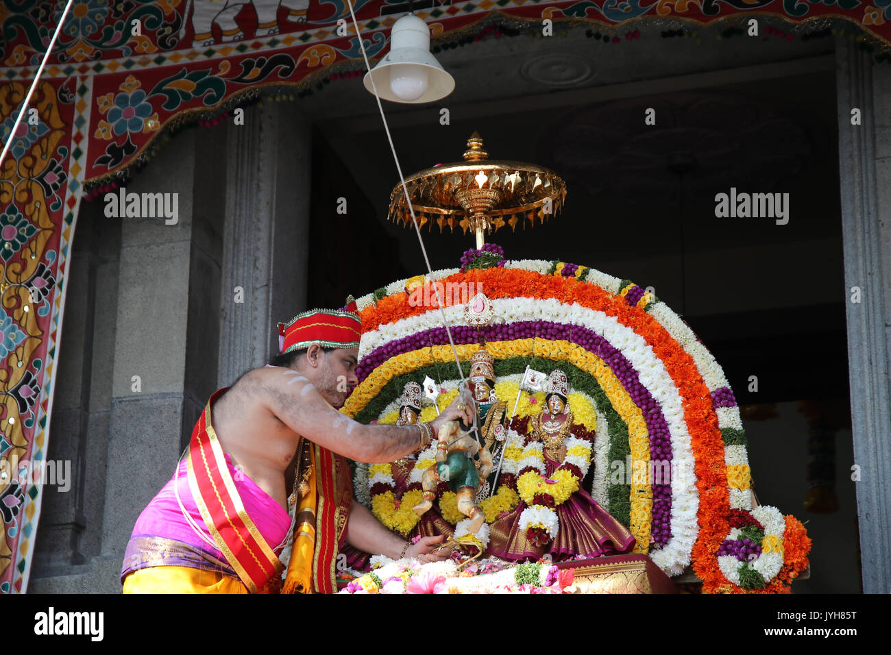 London, UK. 20th Aug, 2017. The London Sri Murgan Temple in East London celebrated the Chariot festival, stating with the blessing of the deities inside the temple, after taken into to a chariot where huge crowds gathering to follow it trough the streets of East Ham, in a colorful rainbow of colours, food was blessed by the priest and passed back for the people to take home and eat Credit: Paul Quezada-Neiman/Alamy Live News Stock Photo