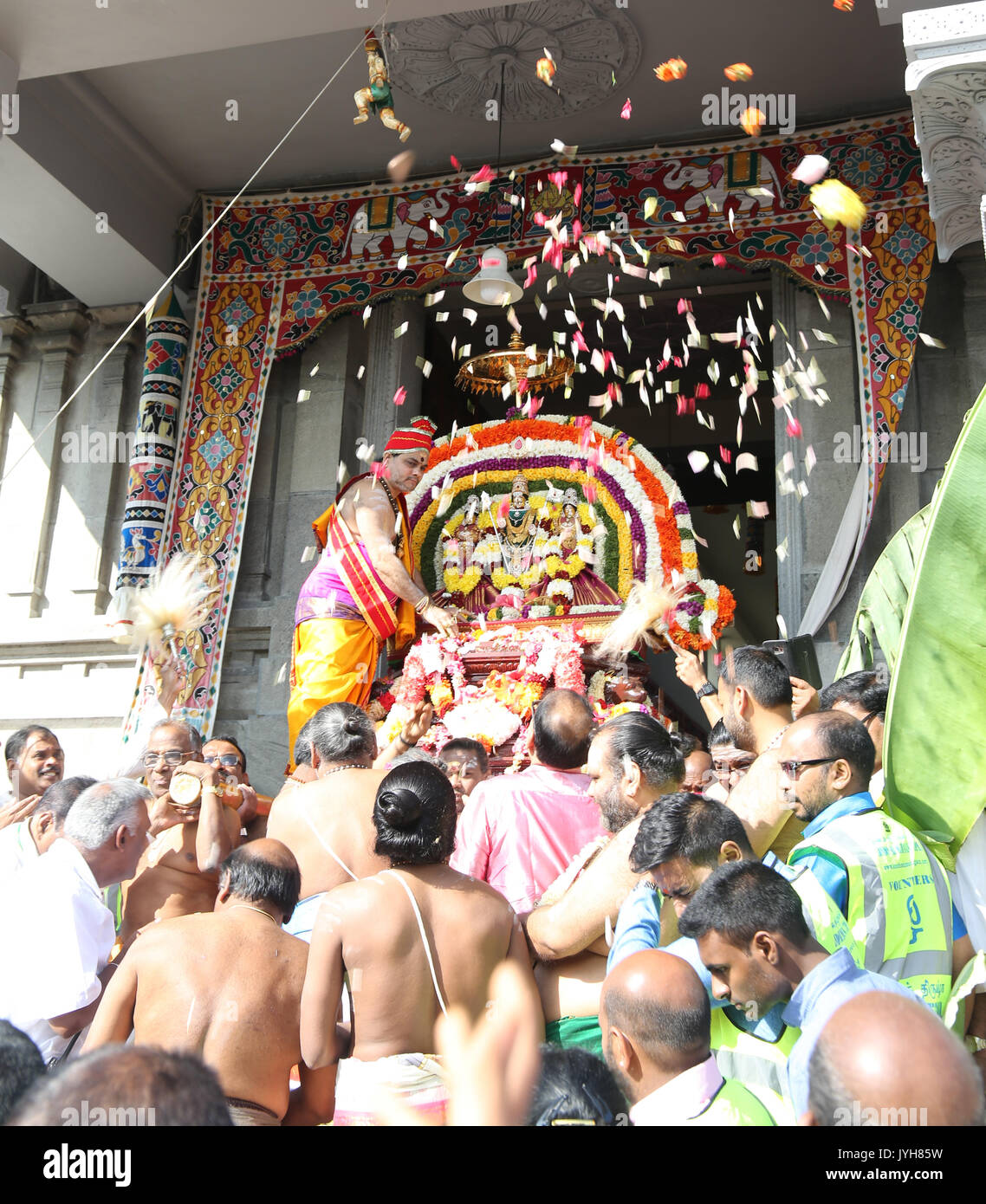 London, UK. 20th Aug, 2017. The London Sri Murgan Temple in East London celebrated the Chariot festival, stating with the blessing of the deities inside the temple, after taken into to a chariot where huge crowds gathering to follow it trough the streets of East Ham, in a colorful rainbow of colours, food was blessed by the priest and passed back for the people to take home and eat Credit: Paul Quezada-Neiman/Alamy Live News Stock Photo