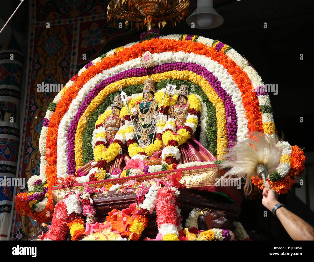 London, UK. 20th Aug, 2017. The London Sri Murgan Temple in East London celebrated the Chariot festival, stating with the blessing of the deities inside the temple, after taken into to a chariot where huge crowds gathering to follow it trough the streets of East Ham, in a colorful rainbow of colours, food was blessed by the priest and passed back for the people to take home and eat Credit: Paul Quezada-Neiman/Alamy Live News Stock Photo