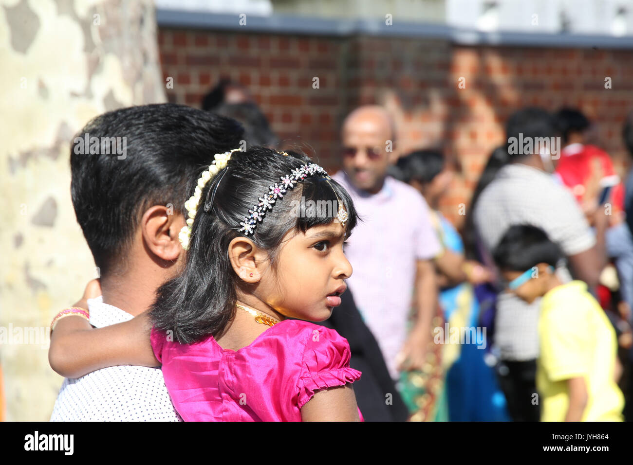 London, UK. 20th Aug, 2017. The London Sri Murgan Temple in East London celebrated the Chariot festival, stating with the blessing of the deities inside the temple, after taken into to a chariot where huge crowds gathering to follow it trough the streets of East Ham, in a colorful rainbow of colours, food was blessed by the priest and passed back for the people to take home and eat Credit: Paul Quezada-Neiman/Alamy Live News Stock Photo