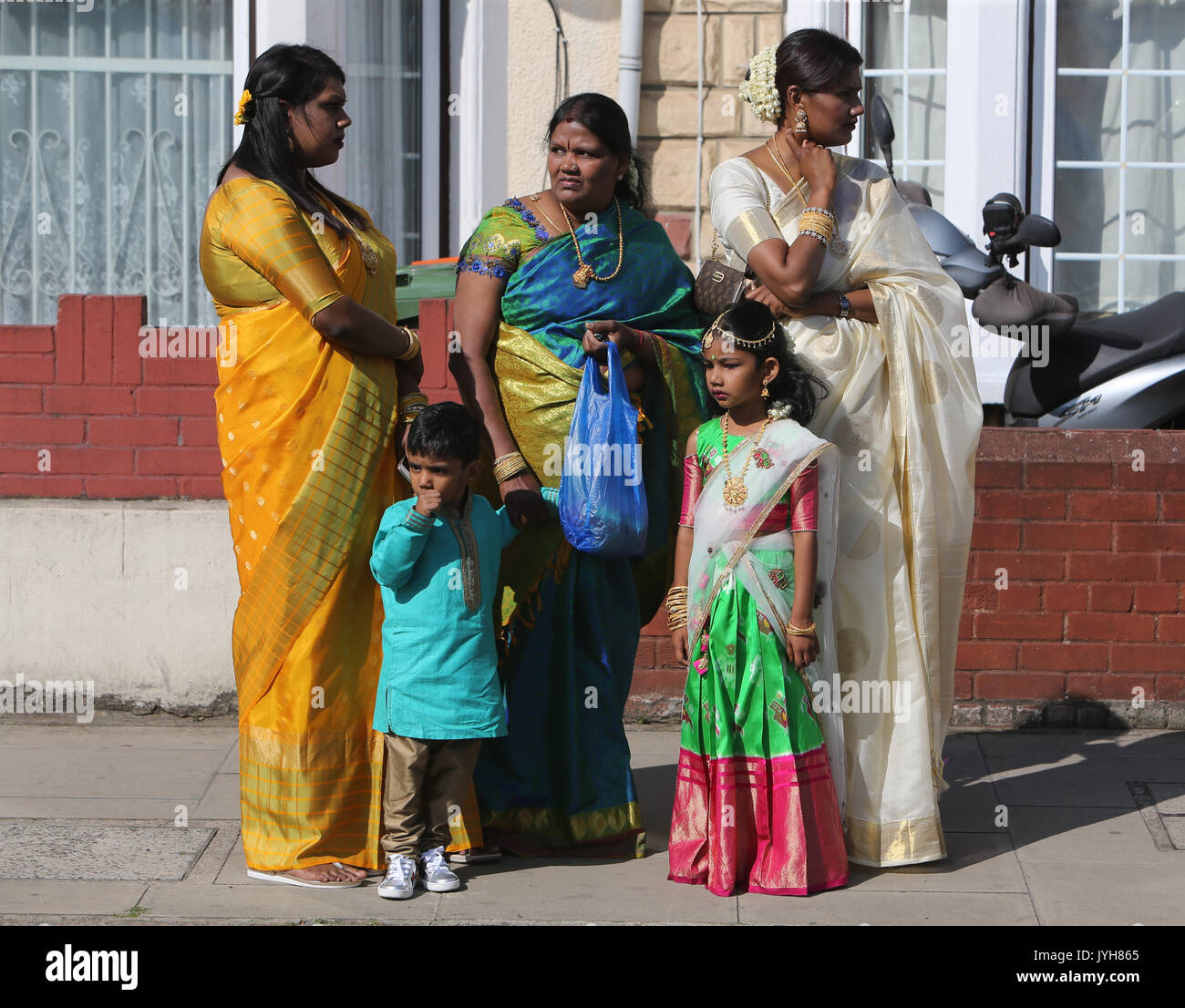 London, UK. 20th Aug, 2017. The London Sri Murgan Temple in East London celebrated the Chariot festival, stating with the blessing of the deities inside the temple, after taken into to a chariot where huge crowds gathering to follow it trough the streets of East Ham, in a colorful rainbow of colours, food was blessed by the priest and passed back for the people to take home and eat Credit: Paul Quezada-Neiman/Alamy Live News Stock Photo