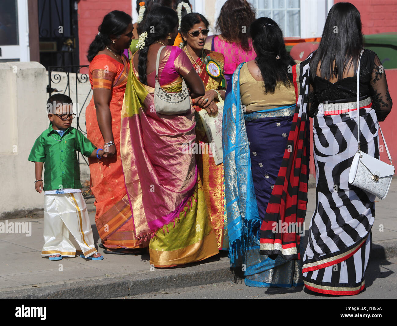 London, UK. 20th Aug, 2017. The London Sri Murgan Temple in East London celebrated the Chariot festival, stating with the blessing of the deities inside the temple, after taken into to a chariot where huge crowds gathering to follow it trough the streets of East Ham, in a colorful rainbow of colours, food was blessed by the priest and passed back for the people to take home and eat Credit: Paul Quezada-Neiman/Alamy Live News Stock Photo