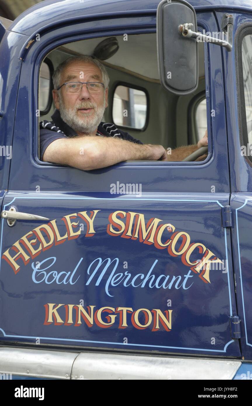 Kington, , UK. 20th Aug, 2017. The Herefordshire market town of Kington came to a standstill while a parade of vintage vehicles made their way to the Kington Vintage Club's 25th Annual Show. A smile from a driver of a vintage Bedford Hedley Simcock coal lorry. Credit: Andrew Compton/Alamy Live News Stock Photo