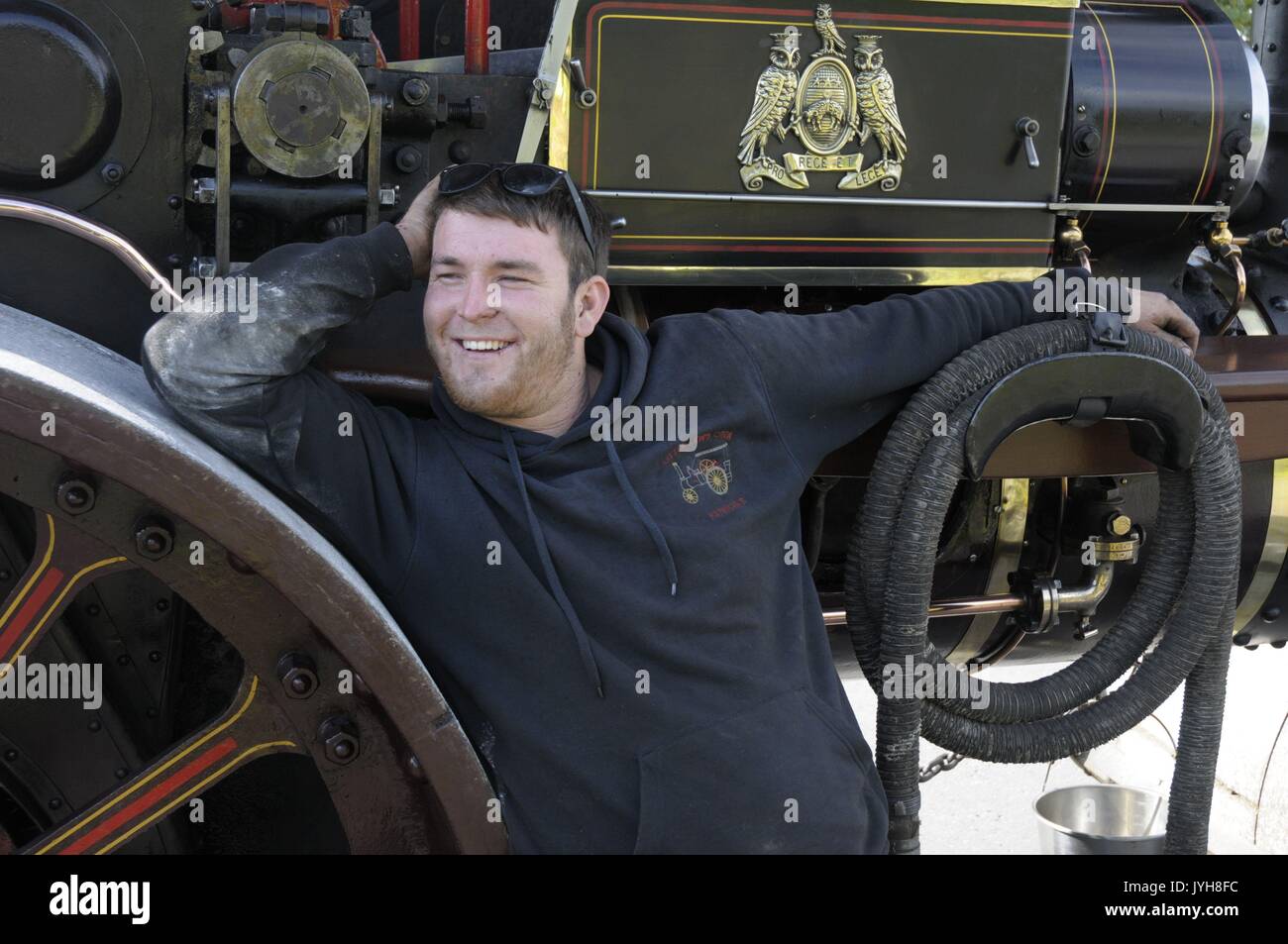 Kington, , UK. 20th Aug, 2017. The Herefordshire market town of Kington came to a standstill while a parade of vintage vehicles made their way to the Kington Vintage Club's 25th Annual Show. Traction driver Lewis Mason enjoys a luagh before the parade. Credit: Andrew Compton/Alamy Live News Stock Photo