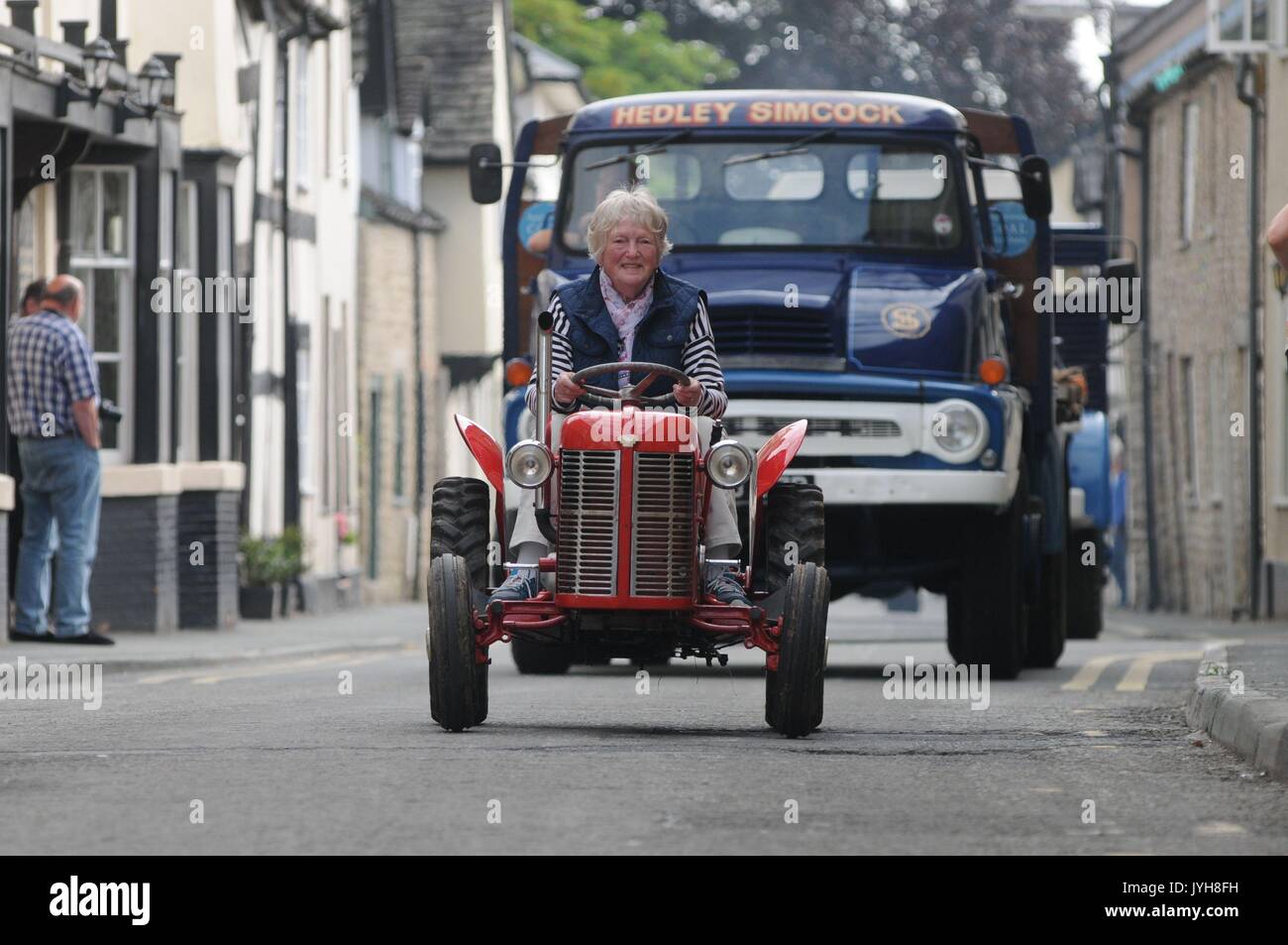 Kington, , UK. 20th Aug, 2017. The Herefordshire market town of Kington came to a standstill while a parade of vintage vehicles made their way to the Kington Vintage Club's 25th Annual Show. A miniature tractor makes its way up Duke Street followed by a Hedley Simcock coal lorry. Credit: Andrew Compton/Alamy Live News Stock Photo