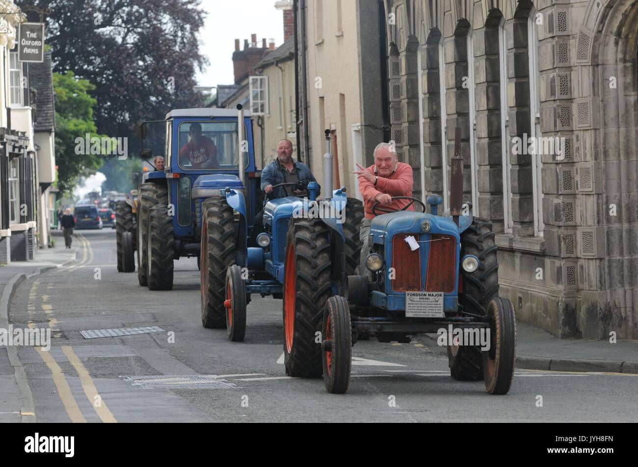 Kington, , UK. 20th Aug, 2017. The Herefordshire market town of Kington came to a standstill while a parade of vintage vehicles made their way to the Kington Vintage Club's 25th Annual Show. Alan Bayliss driving his 1952 Fordson Mason tractor into the town's High Street. Alan has been coming to the show since it started 25 years ago. Credit: Andrew Compton/Alamy Live News Stock Photo
