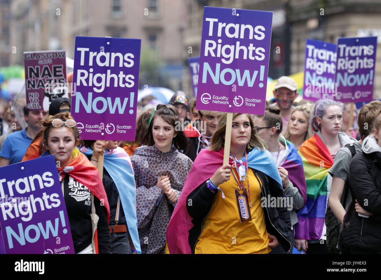 People carrying Trans rights banners take part in the Pride Glasgow parade through the city centre. Stock Photo