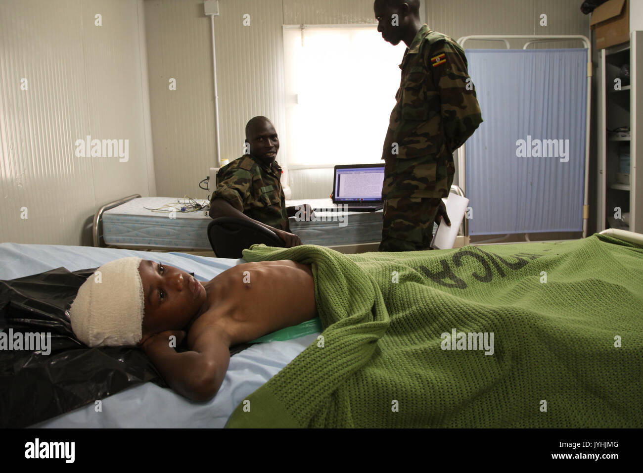 A young boy lies in the AMISOM Level II hospital on July 8 after having been wounded during fighting in Kismayo, Somalia. AU UN IST PHOTO   ILYAS A. ABUKAR (9239999156) Stock Photo