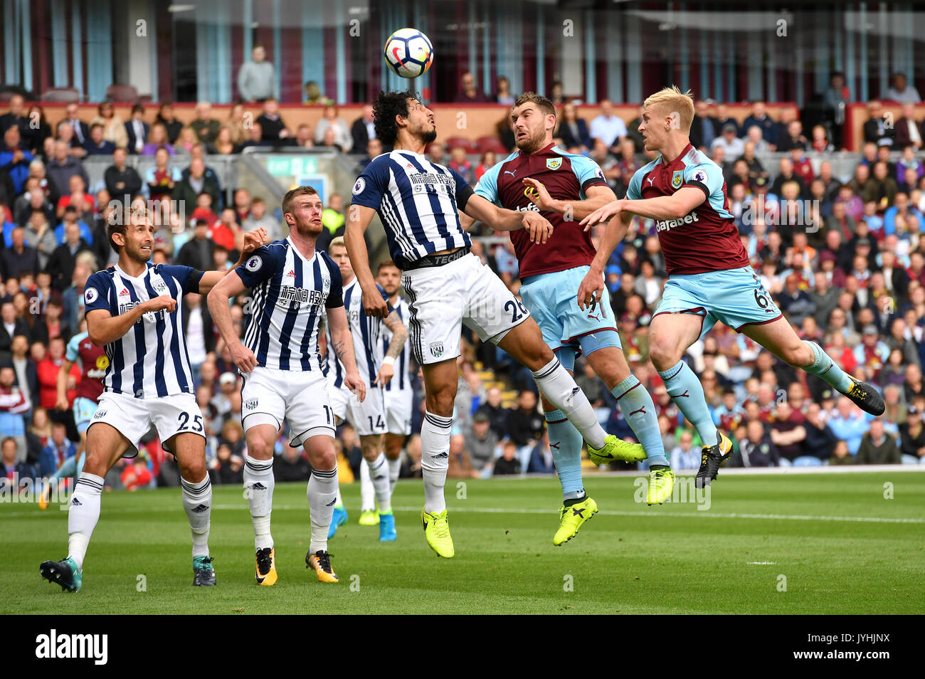 West Bromwich Albion's Ahmed Hegazy (centre) clears away from Burnley's Sam Vokes and Ben Mee (right) during the Premier League match at Turf Moor, Burnley. Stock Photo