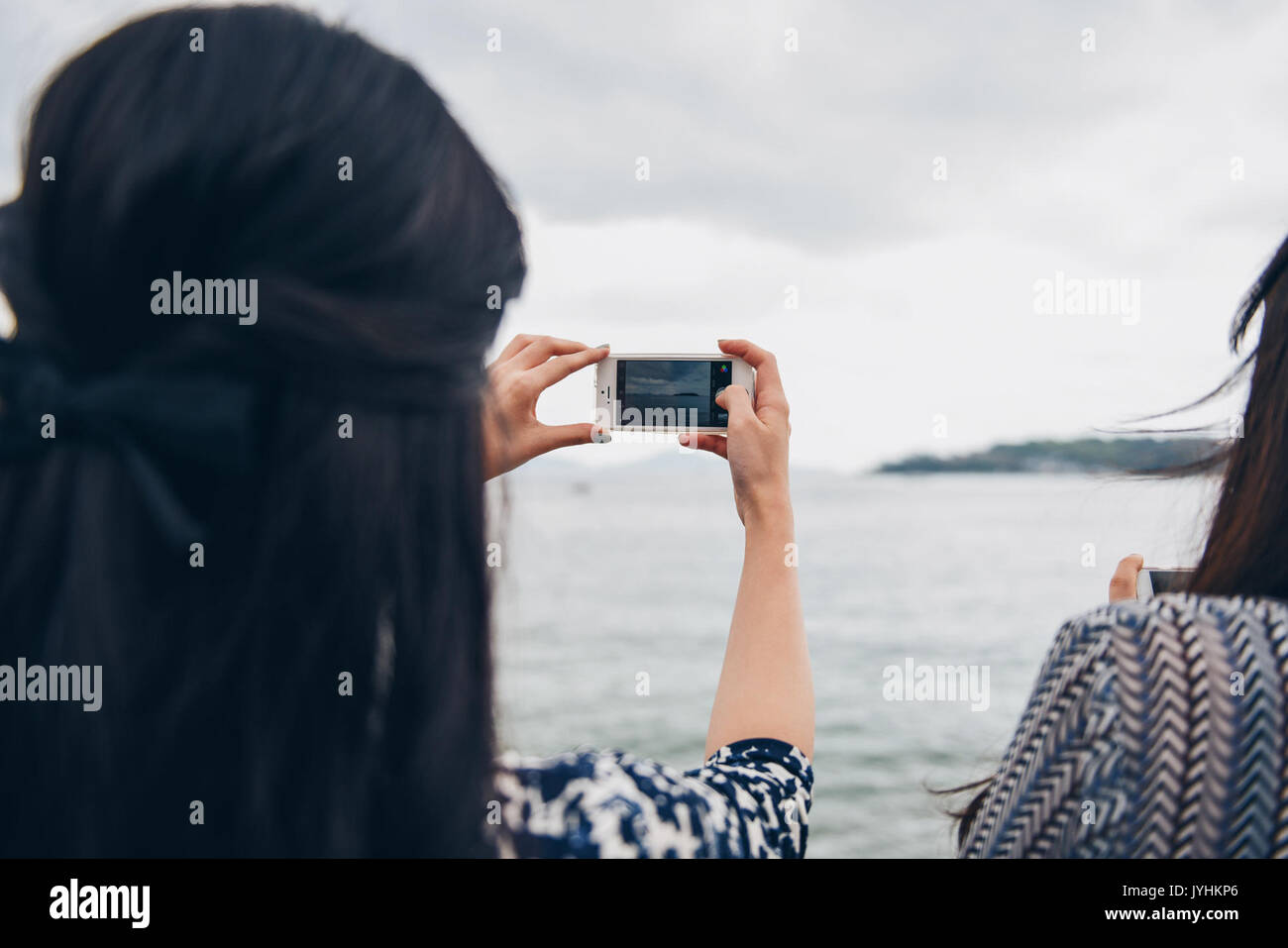 A woman taking a picture with her smartphone Stock Photo