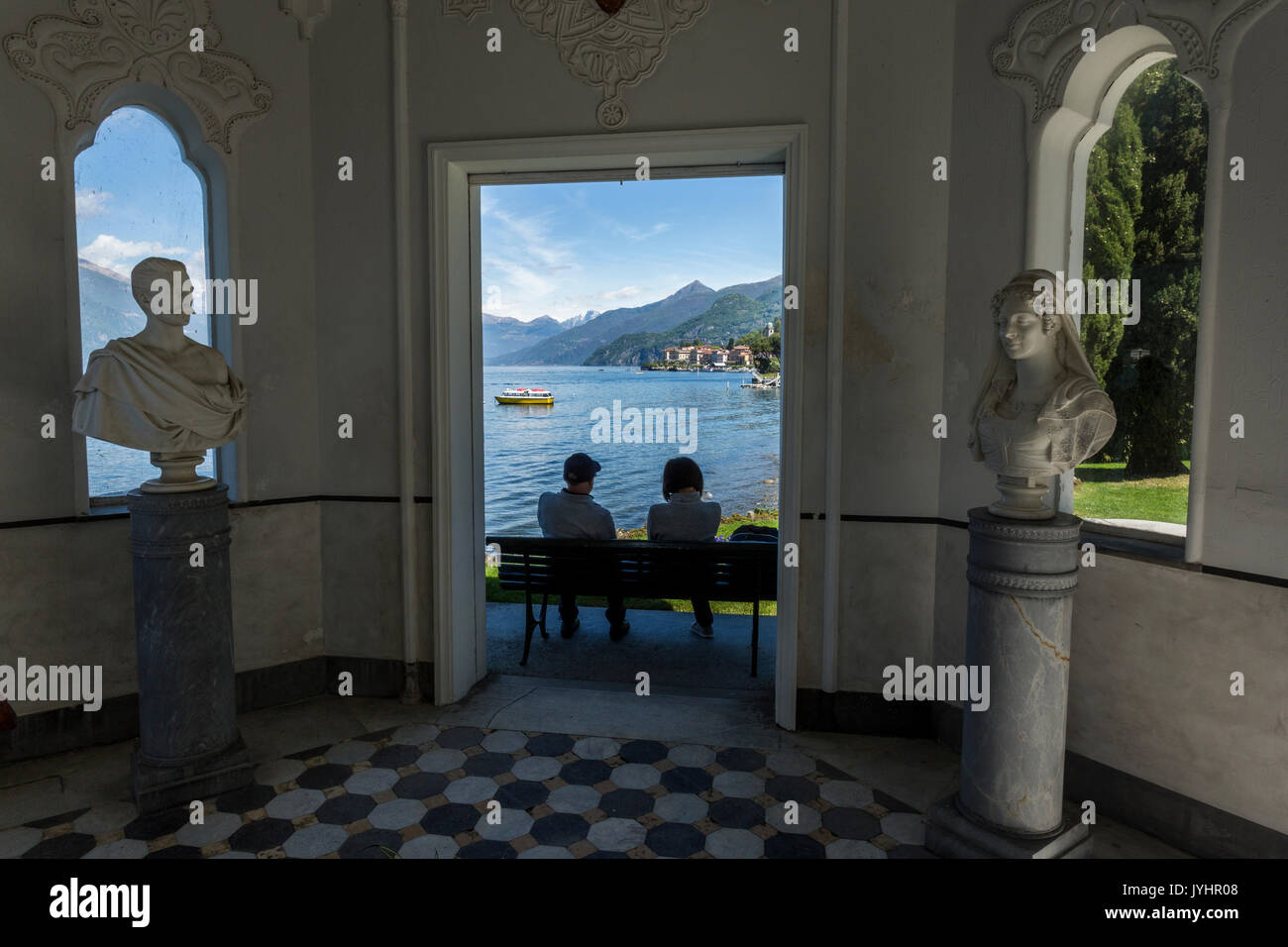 Couple admiring Lake Como from the gardens of Villa Melzi d'Eril in Bellagio, Lombardy, Italy. Stock Photo