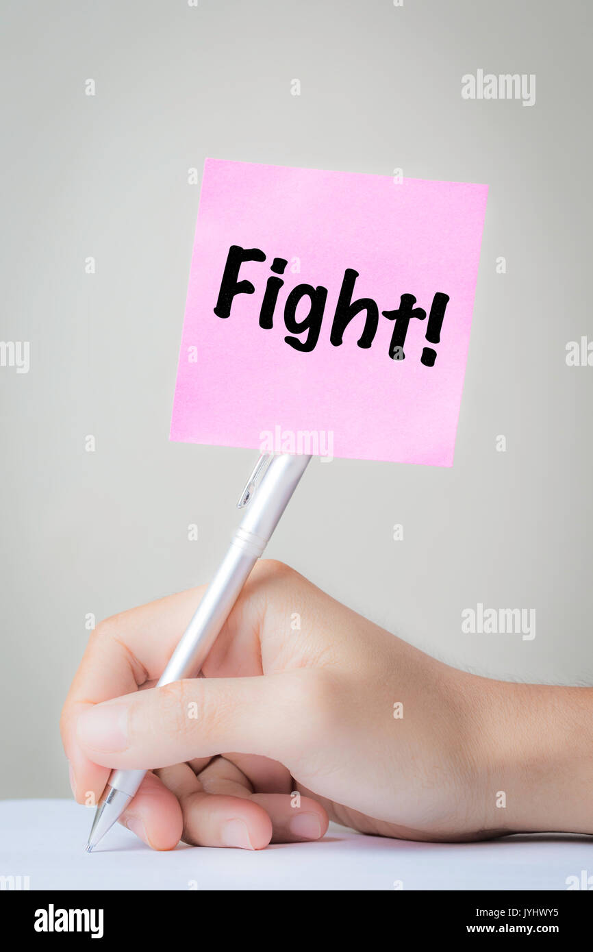 fight on working with hand holding pen Stock Photo