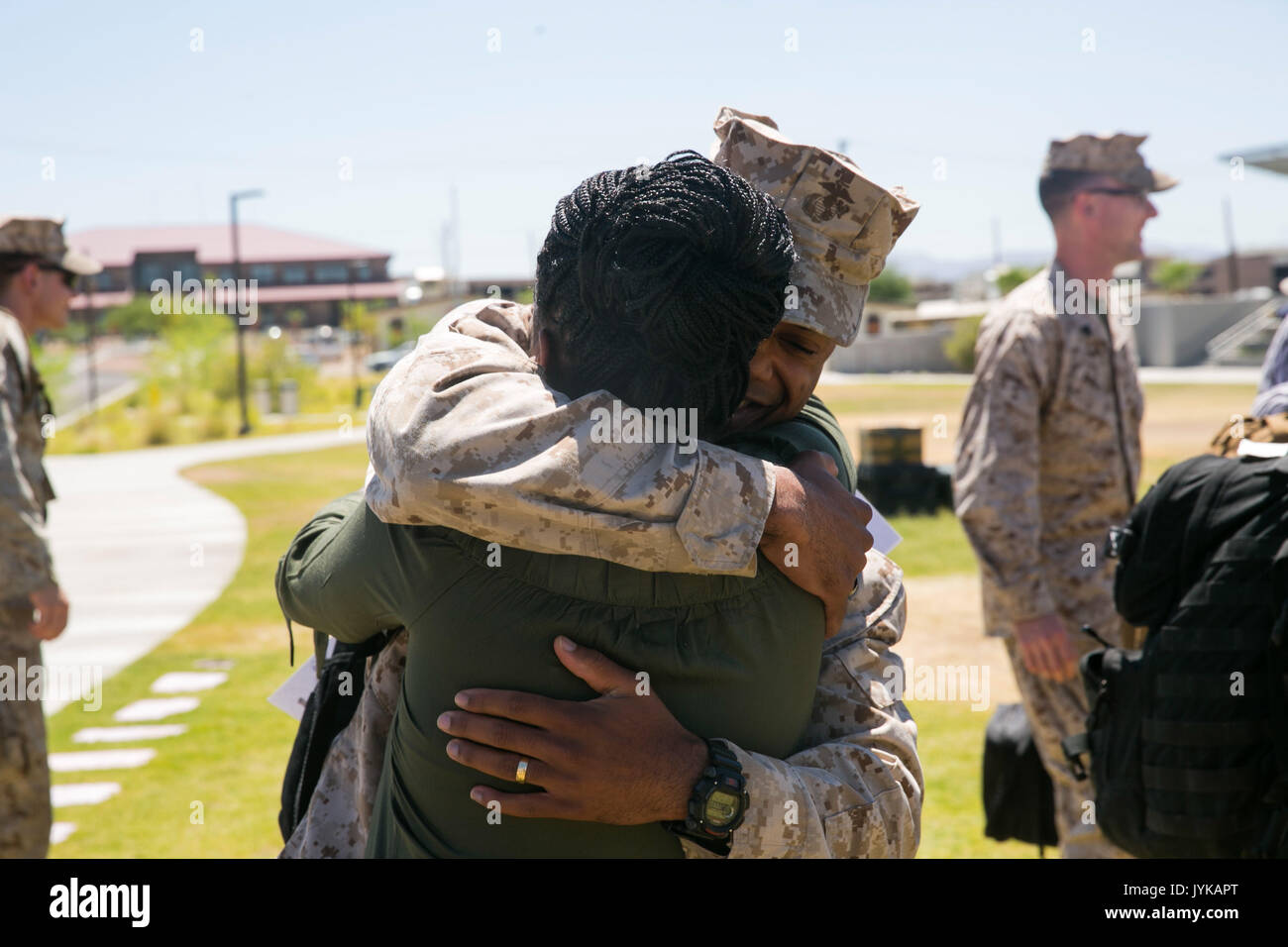Chief Warrant Officer 3 Marcus Gilmore, personnel officer, 7th Marine Regiment, hugs his wife at Victory Park aboard the Marine Corps Air Ground Combat Center, August 18, 2017. 7th Marines completed a nine month deployment as the command element of Special Purpose Marine Air-Ground Task Force – Crisis Response – Central Command 17.1. (U.S. Marine Corps photo by Lance Cpl. Isaac Cantrell) Stock Photo