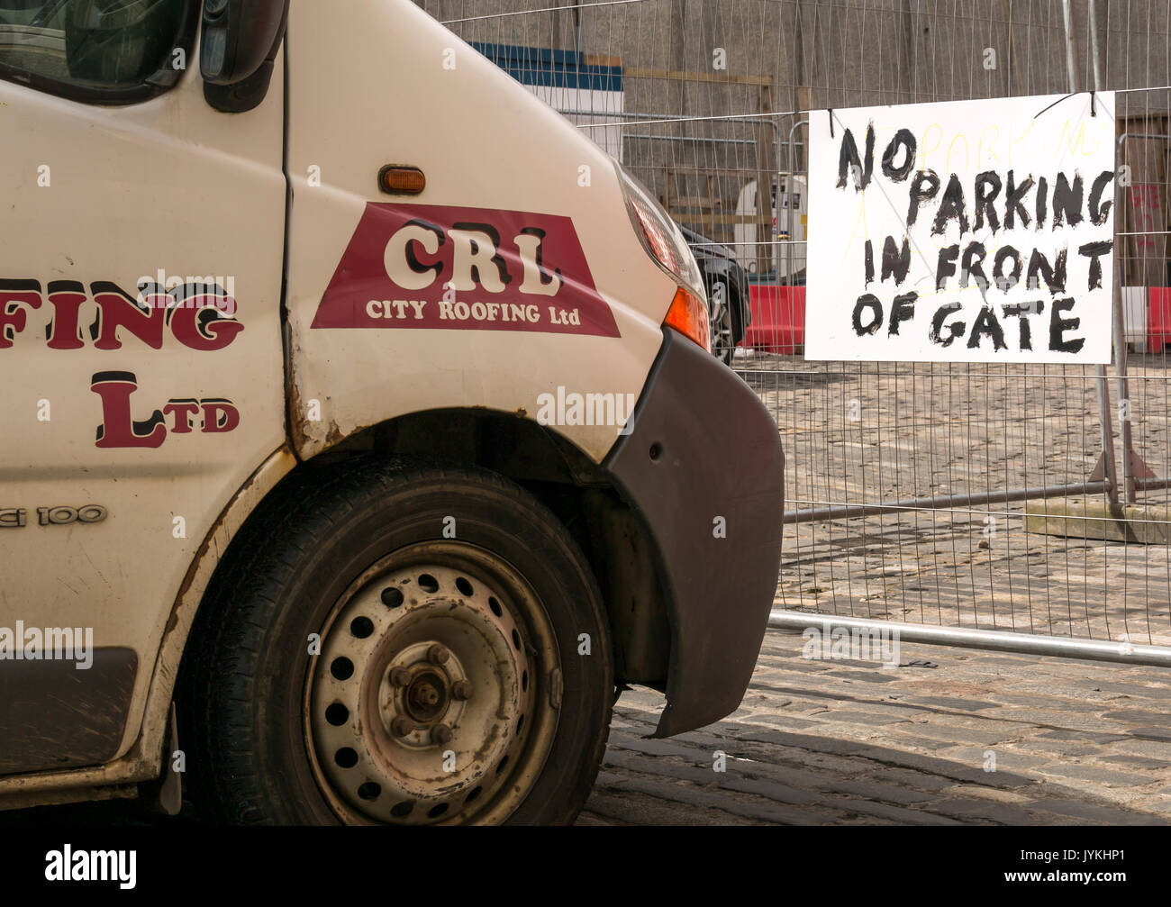 White van parked directly in front of hand painted sign saying No Parking in Front of Gate, Edinburgh , Scotland, UK Stock Photo