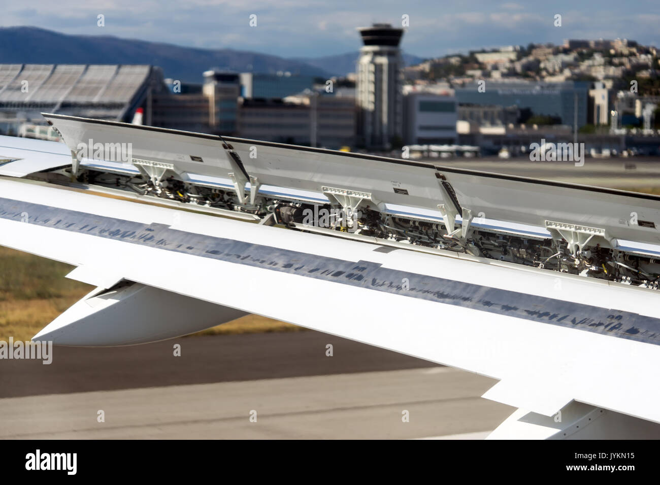 aircraft landing in airport wing flaps in action Stock Photo