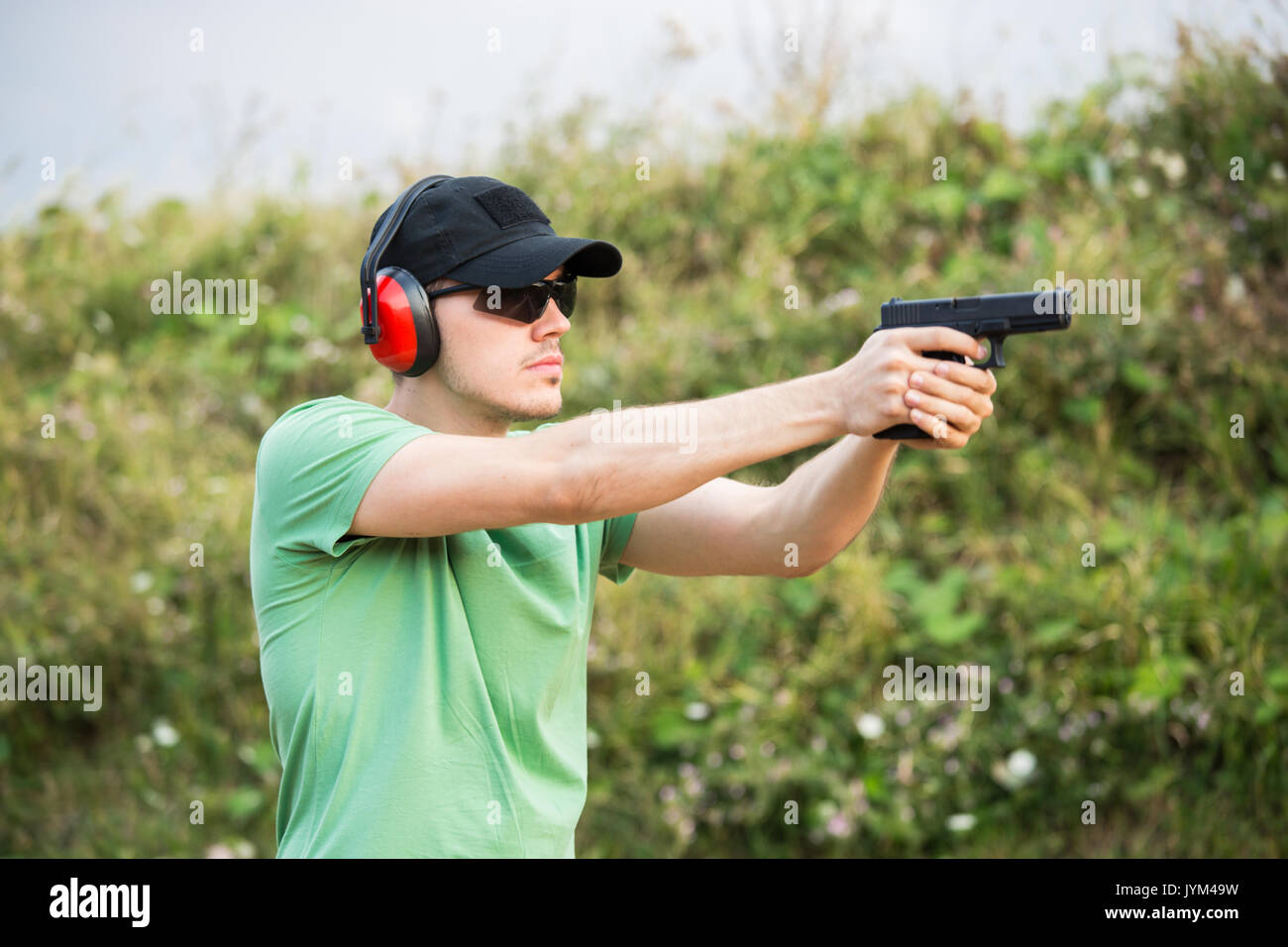 Special force policeman soldier from military army camp wants to shoot the enemy with gun glock desert eagle pistol and full body equipment gun holder Stock Photo