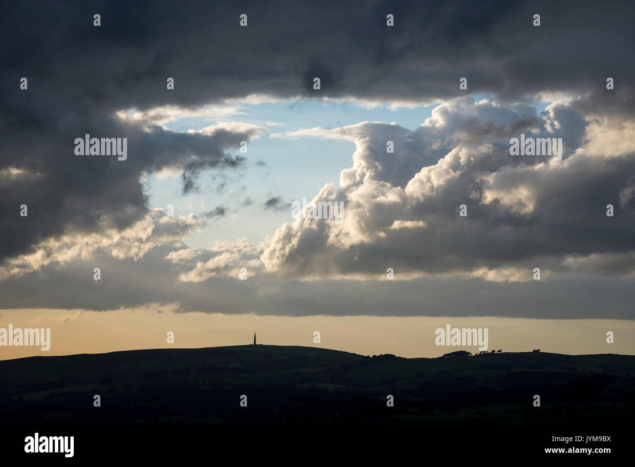 Sutton Common radio mast, Croker Hill, Cheshire. Seen beneath a sky of big summer clouds. Stock Photo