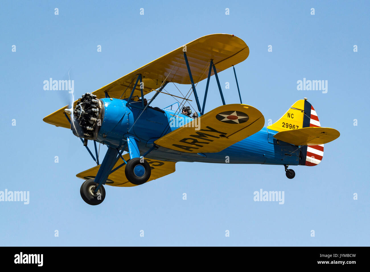 1940 Waco UPF-7 biplane in U.S Army markings in flight during the 2017 Nevada County Airfest Stock Photo