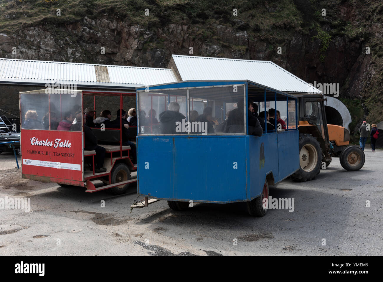 Arriving passengers take the tractor and trailer from the harbour for a