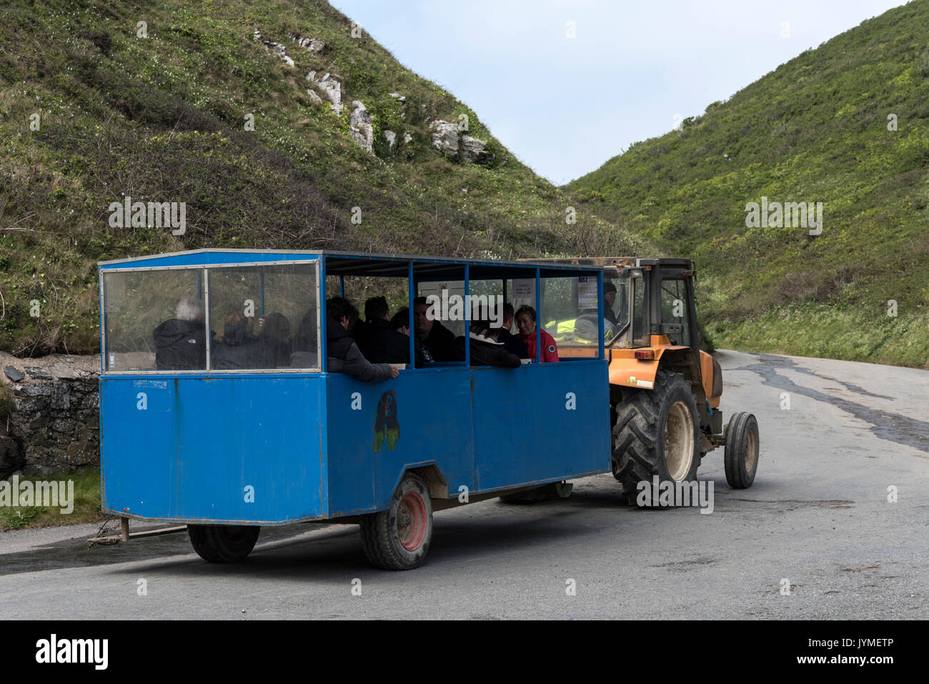 Arriving passengers take the tractor and trailer from the harbour for a