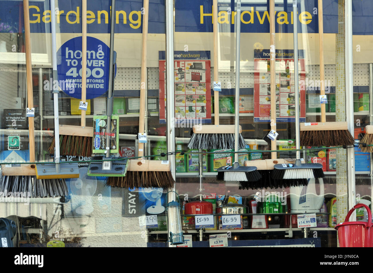a gardening and hardware shop window showing brushes and brooms as well as  other hardware items for sale on the high street at wadebridge in cornwall  Stock Photo - Alamy