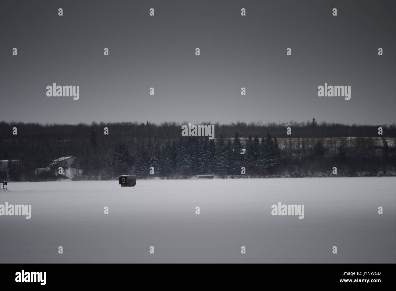 The small ice fishing shack located on a frozen lake in Bonnyville